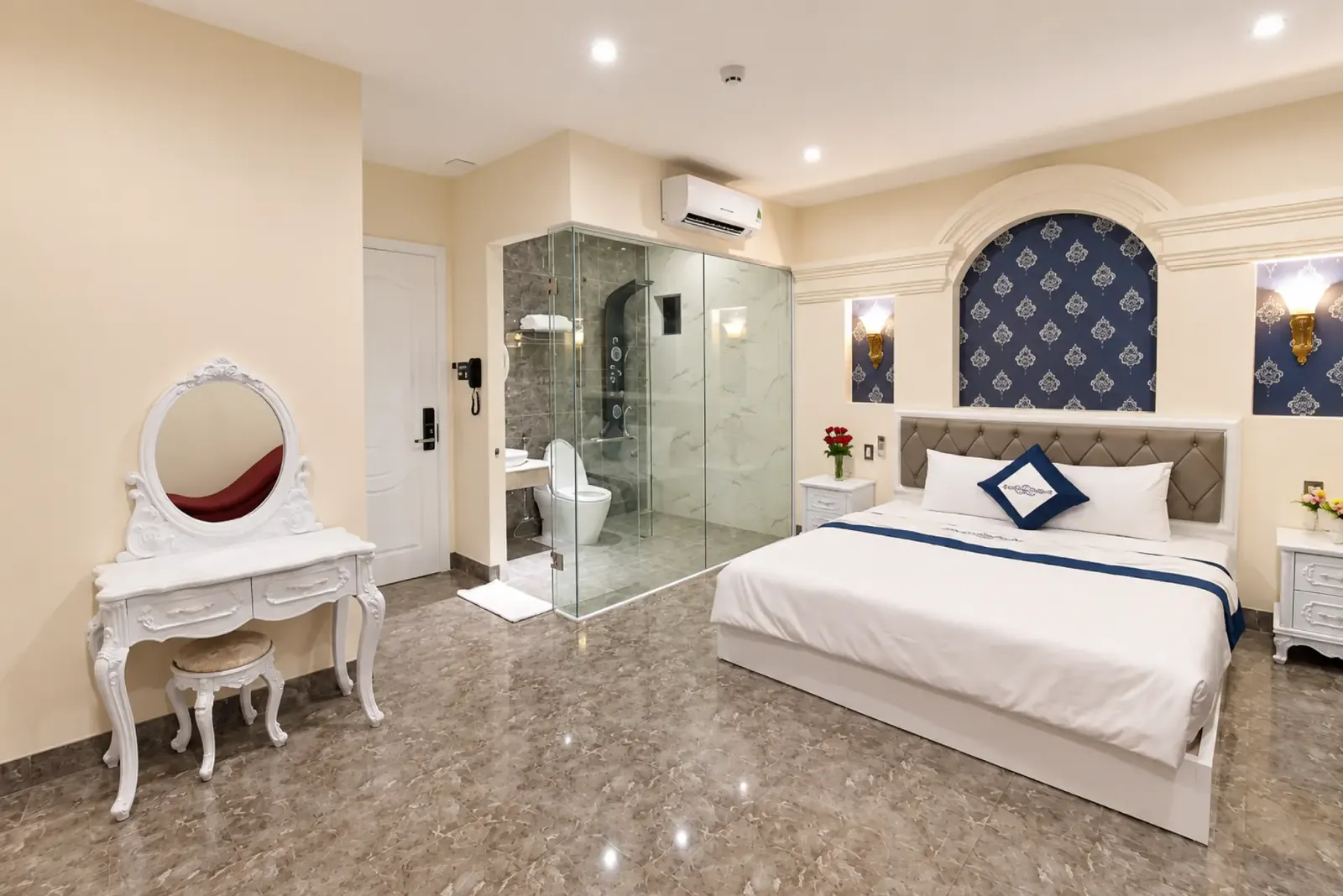 Bright double room at Sun Beach Hotel with a glass-enclosed bathroom
