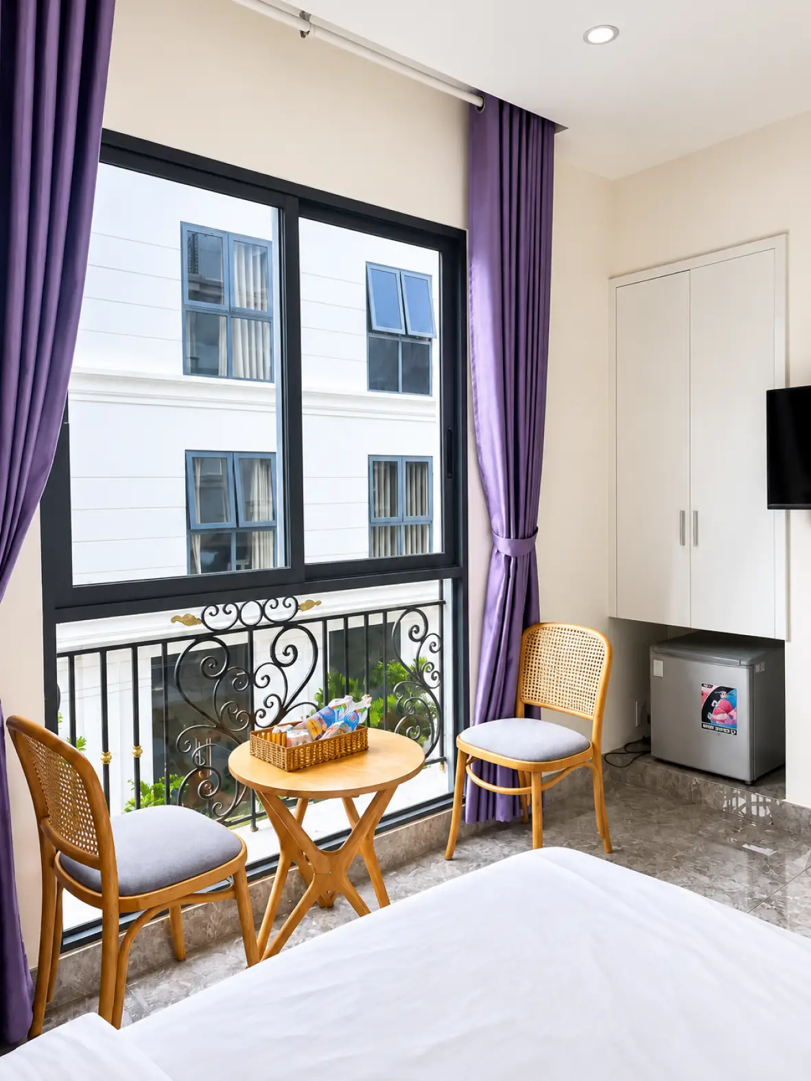 Furnished room balcony with seating at Sun Beach Hotel